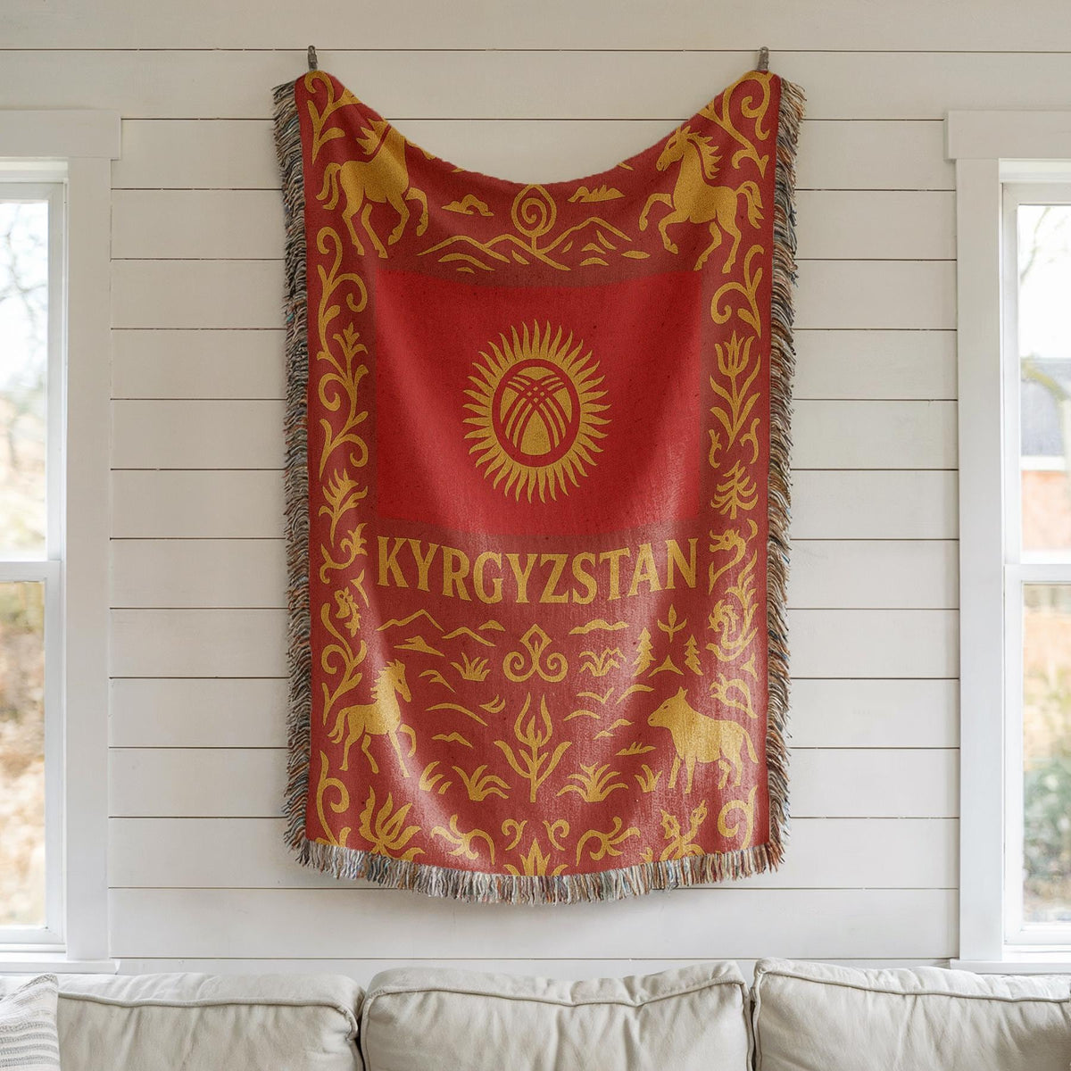 Red and gold Kyrgyzstan woven blanket with horses, mountains, ornamental borders, and fringe edges