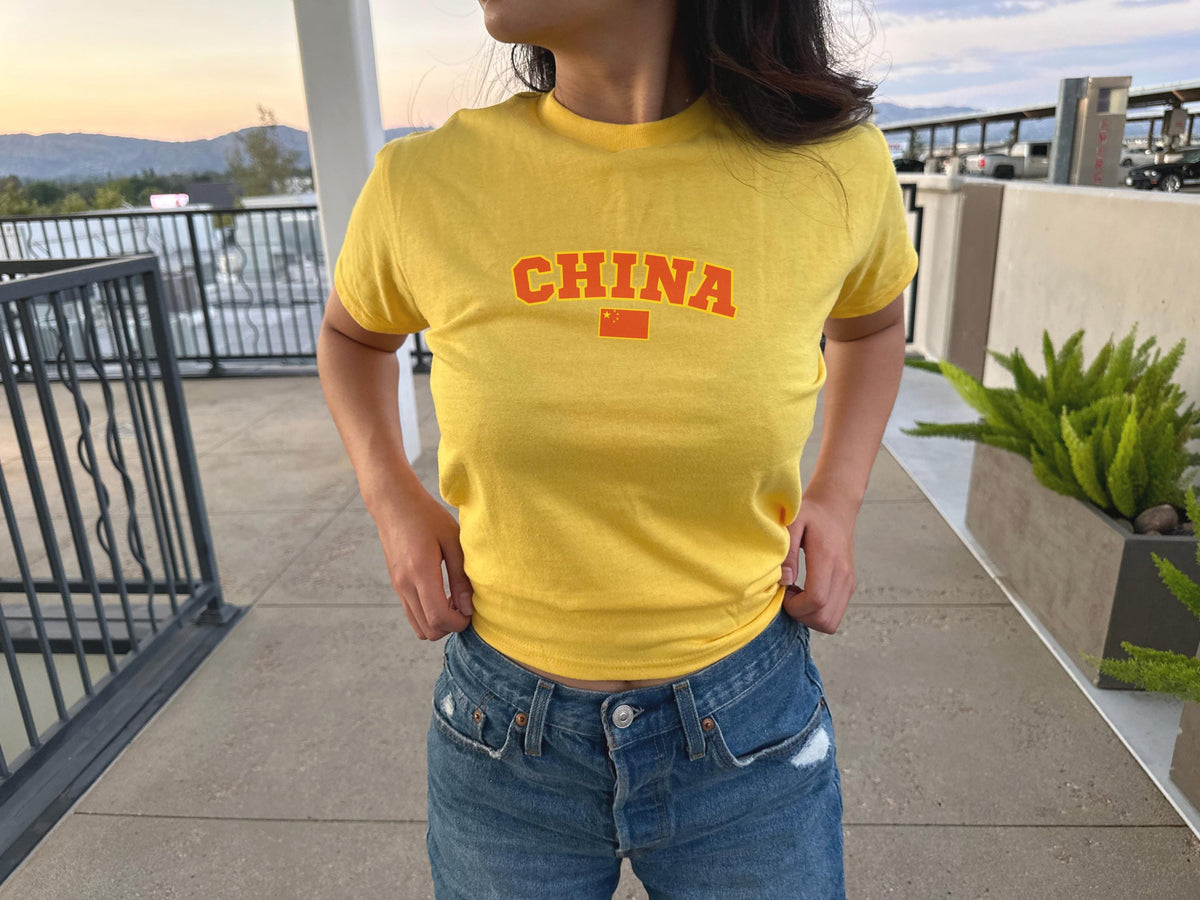 Navy baby tee with varsity CHINA lettering and Chinese flag graphic