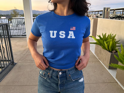 Navy fitted baby tee with bold USA lettering and small American flag graphic