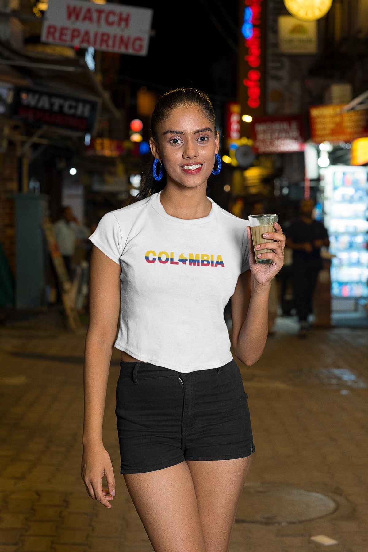 Black baby tee with Colombia wordmark in yellow, blue, and red flag colors and map silhouette