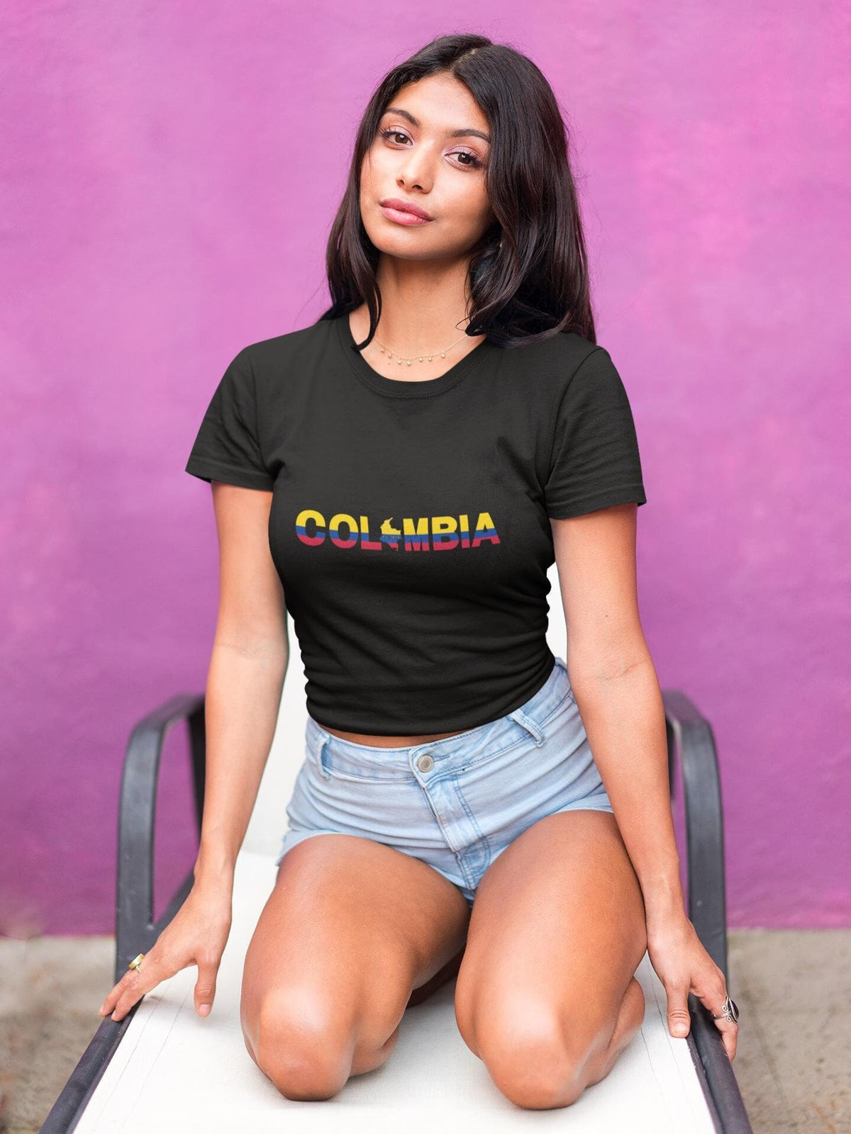 Black baby tee with Colombia wordmark in yellow, blue, and red flag colors and map silhouette