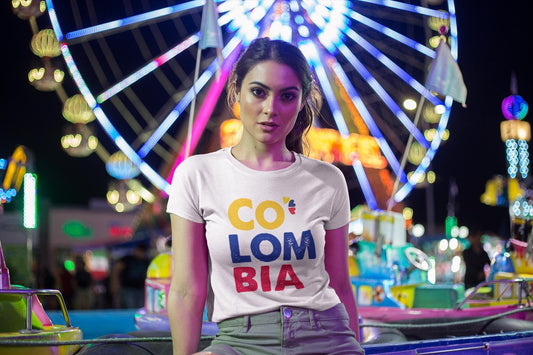 White baby tee with CO LOM BIA text in yellow, blue and red Colombia flag colors