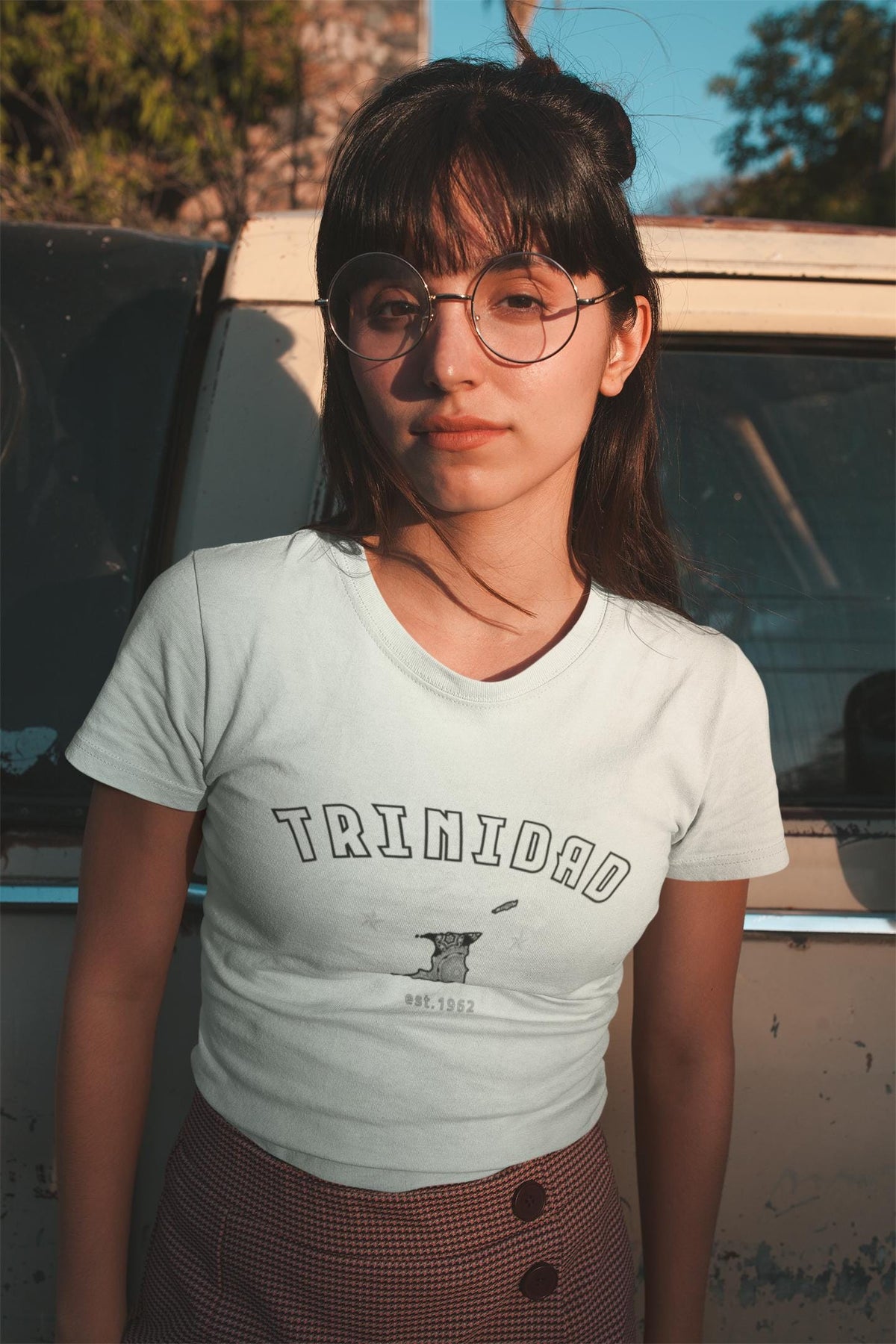 Trinidad baby tee design with arched white lettering, island graphic, stars, and 1962 detail