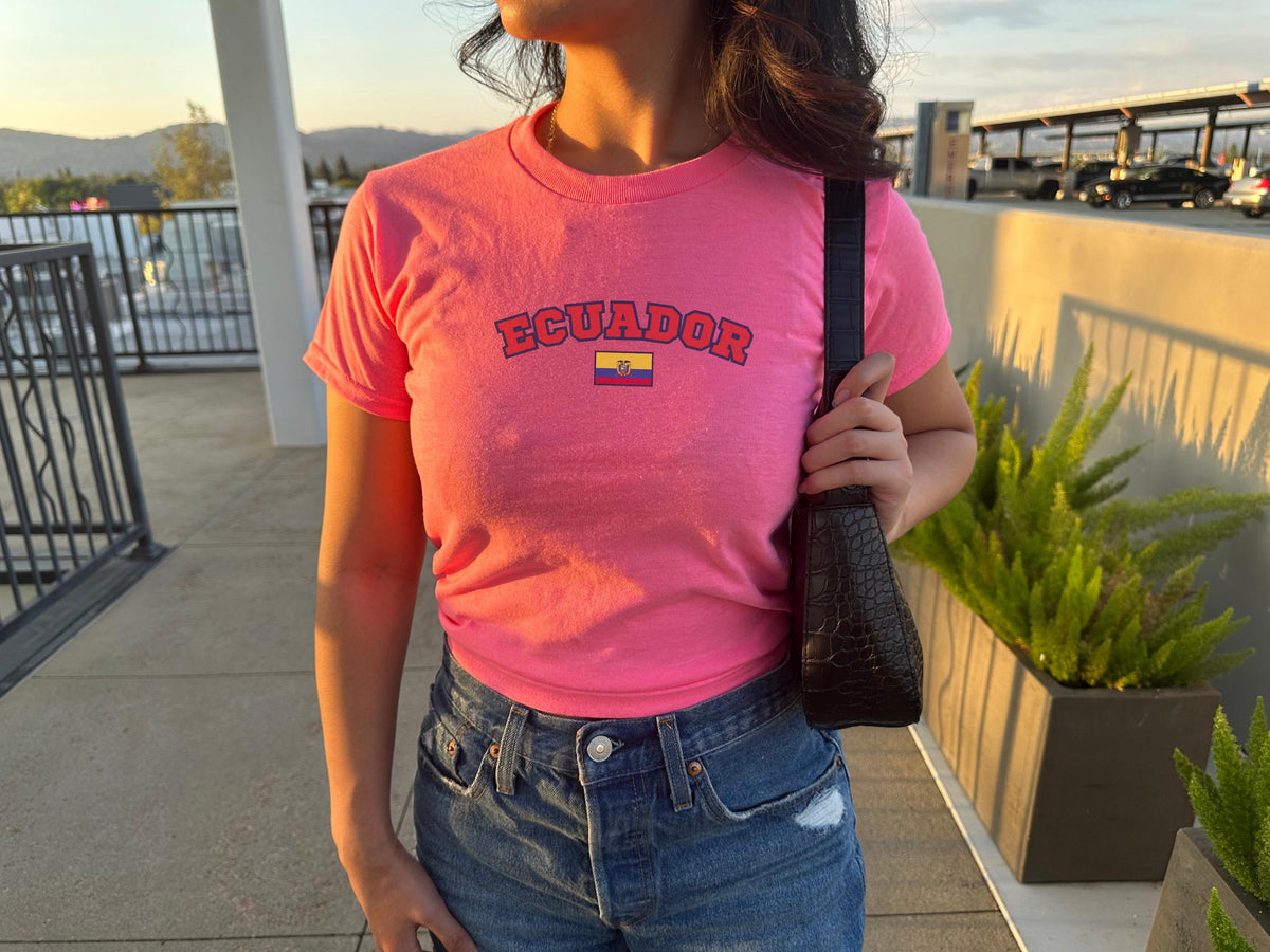 Yellow baby tee with arched Ecuador lettering and small Ecuador flag graphic