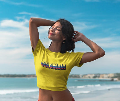 Yellow baby tee with a Colombia wordmark in flag colors on the chest