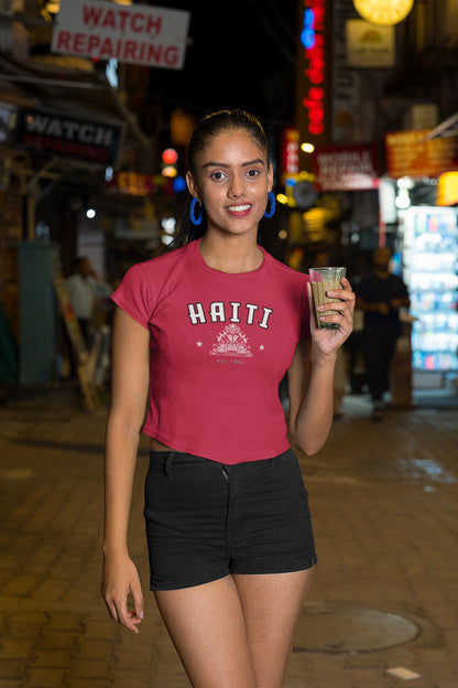 Blue baby tee with Haiti collegiate lettering, coat of arms graphic, stars, and est. 1804 text