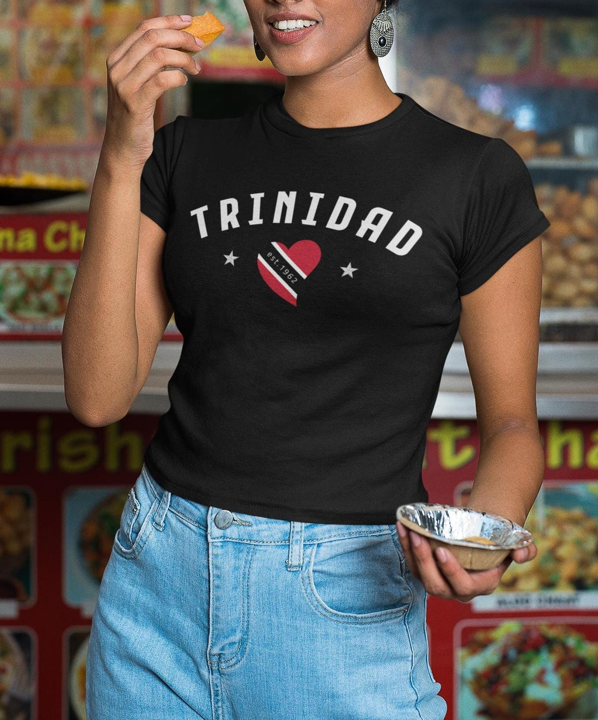 Black baby tee with Trinidad wordmark, flag heart, stars, and est. 1962 design