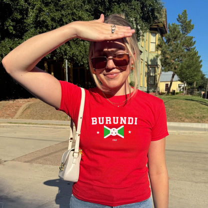 Red baby tee with BURUNDI varsity lettering, Burundi flag graphic, stars, and 1962.