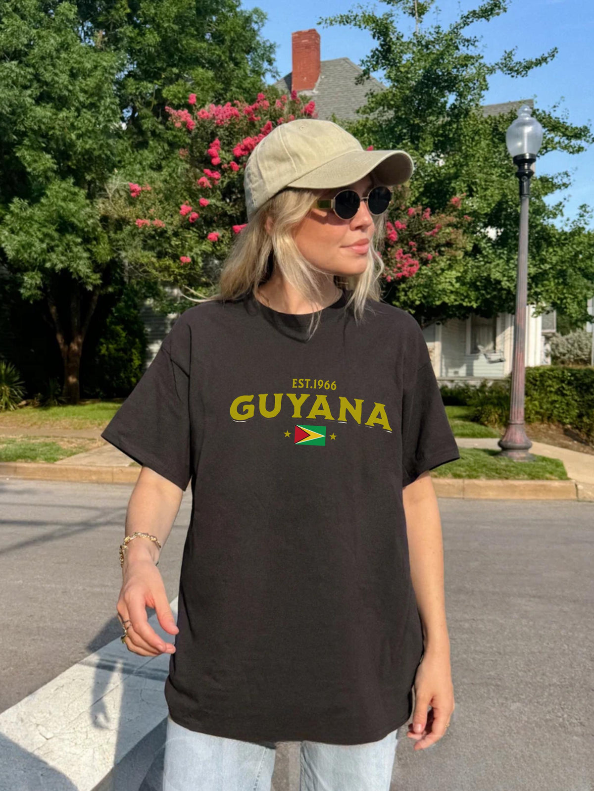 Black T-shirt with EST.1966 Guyana lettering, Guyana flag graphic, and star accents