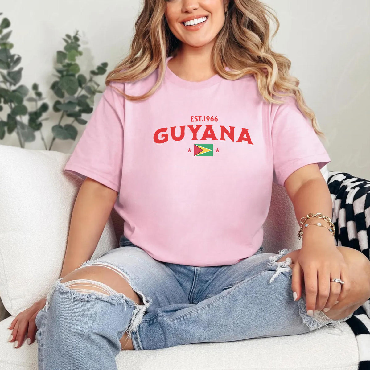 Black T-shirt with EST.1966 Guyana lettering, Guyana flag graphic, and star accents