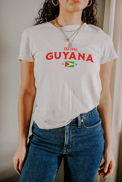 Black T-shirt with EST.1966 Guyana lettering, Guyana flag graphic, and star accents