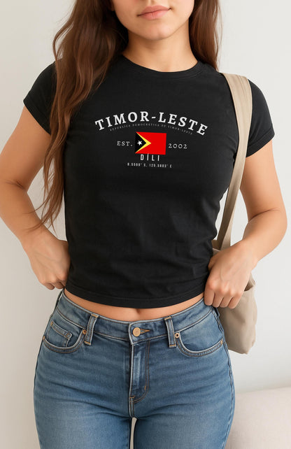 Red baby tee with Timor-Leste flag, Dili text, Est. 2002, and coordinates design