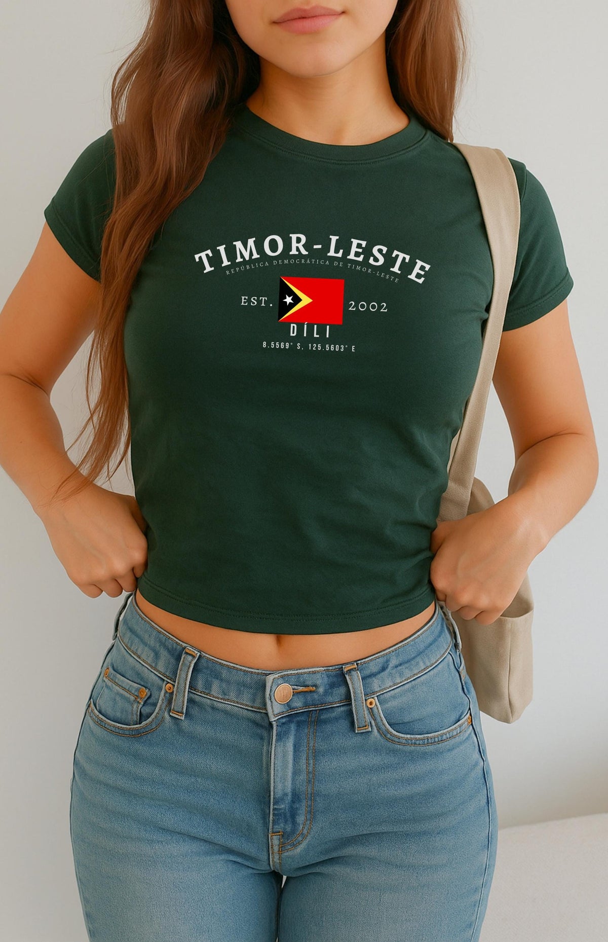 Red baby tee with Timor-Leste flag, Dili text, Est. 2002, and coordinates design