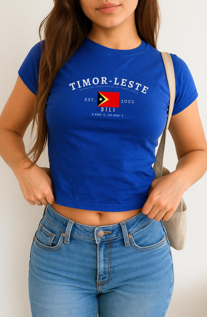 Red baby tee with Timor-Leste flag, Dili text, Est. 2002, and coordinates design