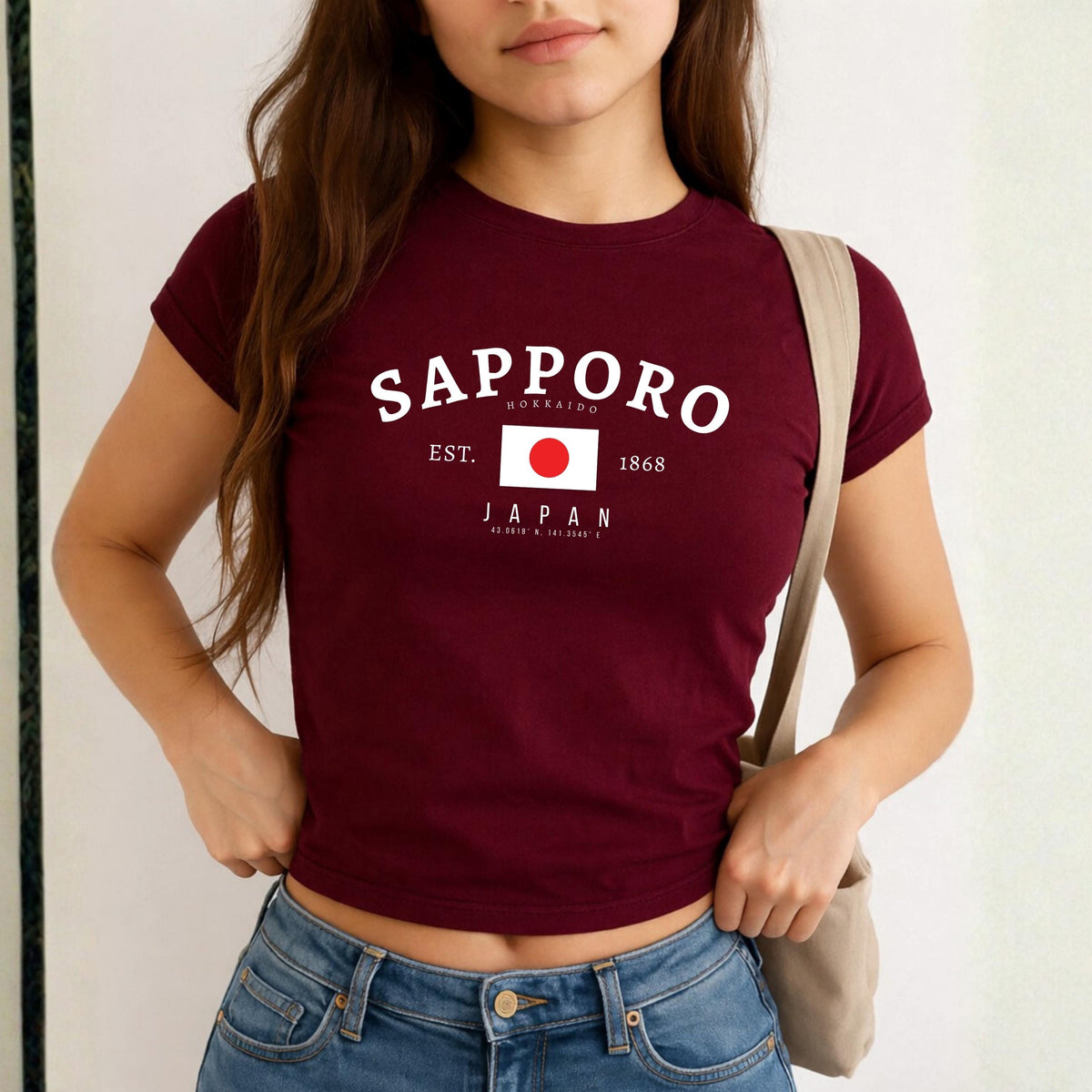 Navy baby tee with Sapporo Hokkaido Japan text, Japanese flag, EST. 1868, and coordinates