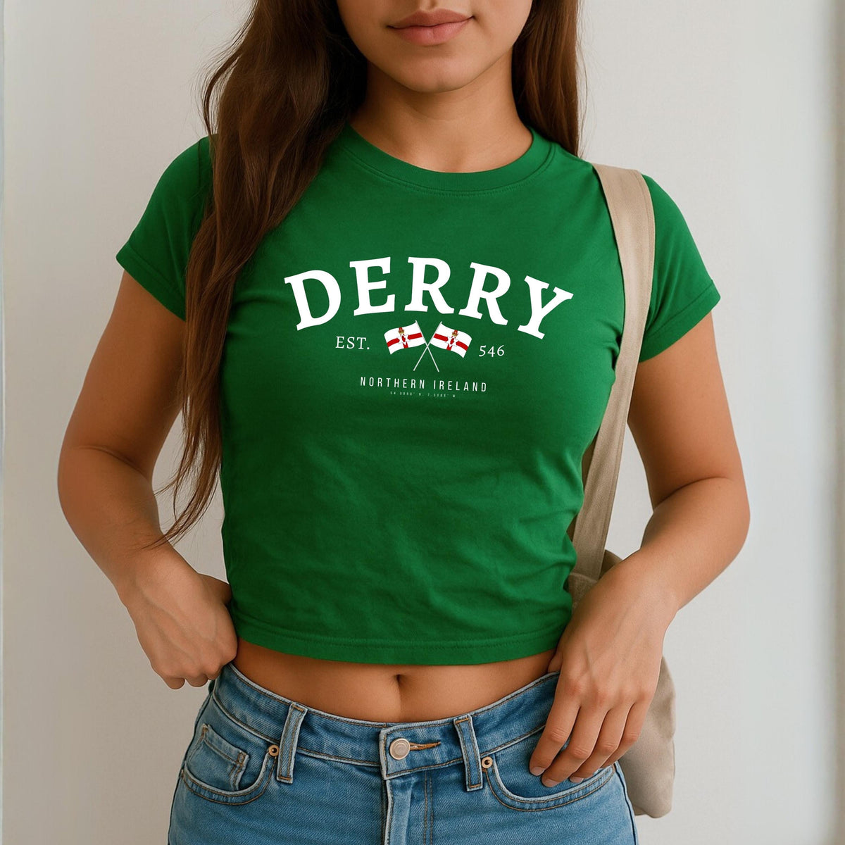 Derry Northern Ireland baby tee design with arched lettering, crossed flags, EST. 546, and coordinates
