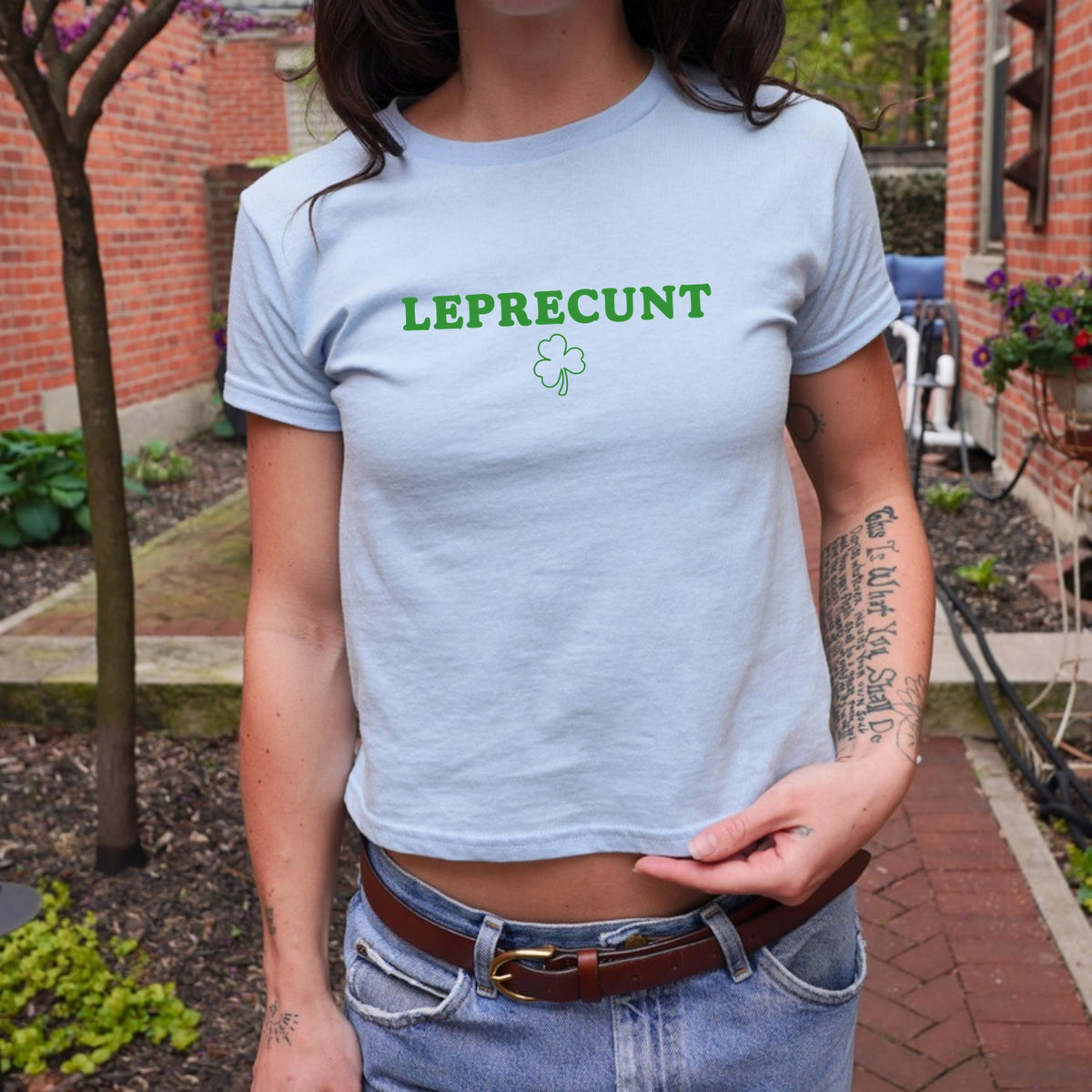 White baby tee with green LEPRECUNT lettering and a shamrock graphic