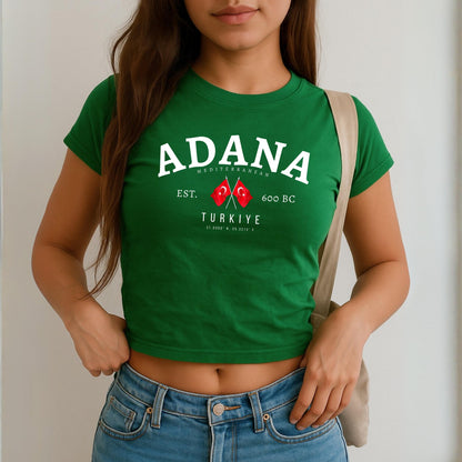 Red baby tee with white Adana Türkiye text, crossed Turkish flags, EST. 600 BC and coordinates