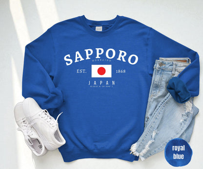 Navy sweatshirt with arched Sapporo Hokkaido Japan text, Japanese flag, EST. 1868, and coordinates