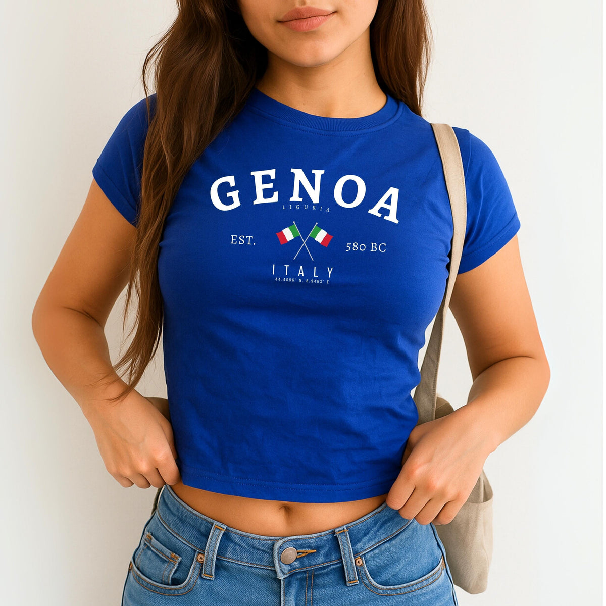 Navy baby tee with Genoa Liguria Italy design, crossed Italian flags, est. 580 BC, and coordinates