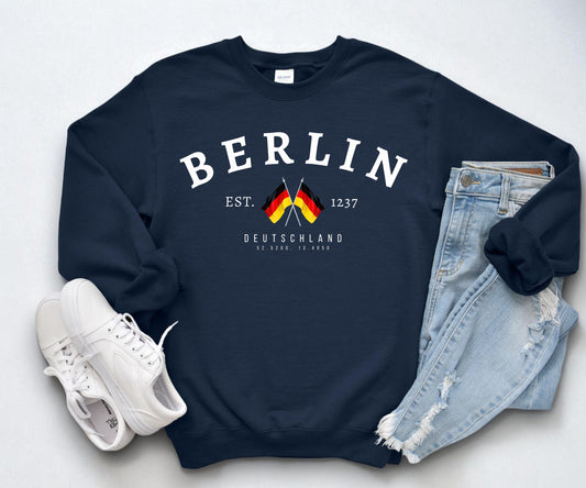 Navy sweatshirt with arched Berlin text, crossed German flags, Deutschland lettering, and 1237 detail