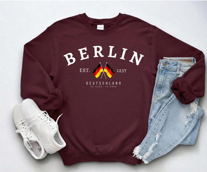 Navy sweatshirt with arched Berlin text, crossed German flags, Deutschland lettering, and 1237 detail