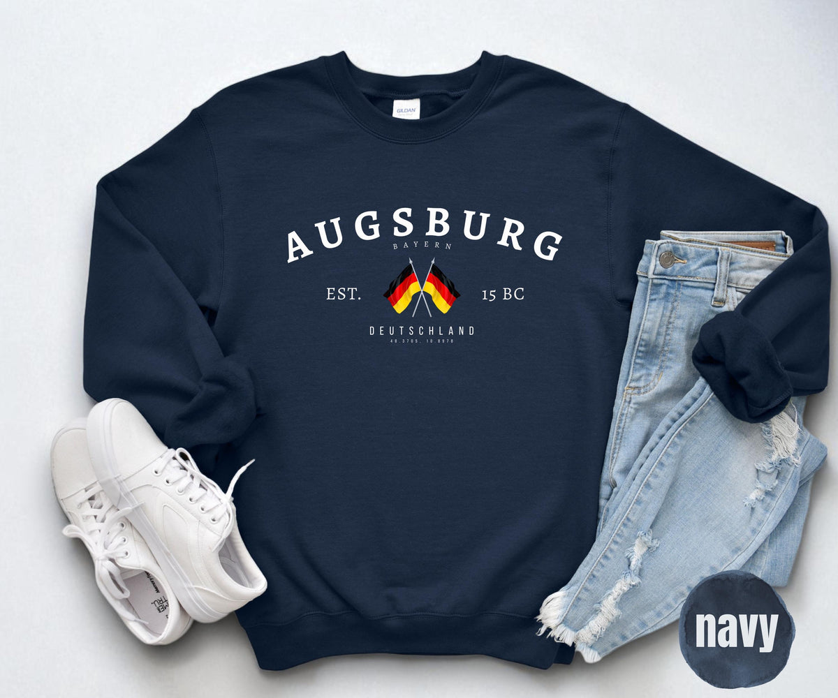 Maroon sweatshirt with arched Augsburg text, Bayern and Deutschland lettering, and crossed German flags.
