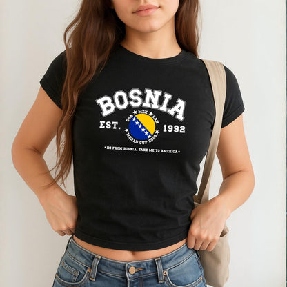 Blue Bosnia baby tee with collegiate flag design, World Cup 2026 text, and take me to America slogan