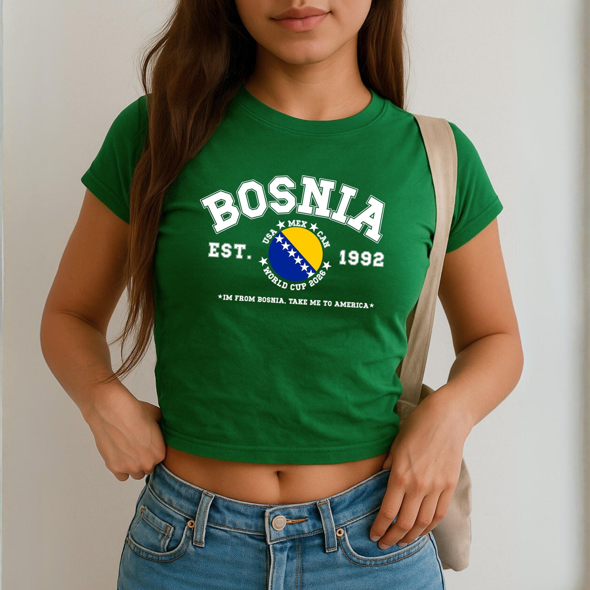 Blue Bosnia baby tee with collegiate flag design, World Cup 2026 text, and take me to America slogan