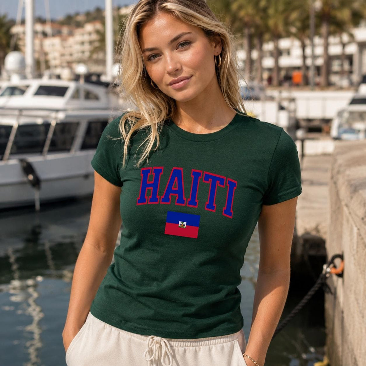 Navy baby tee with bold HAITI varsity lettering and Haitian flag graphic