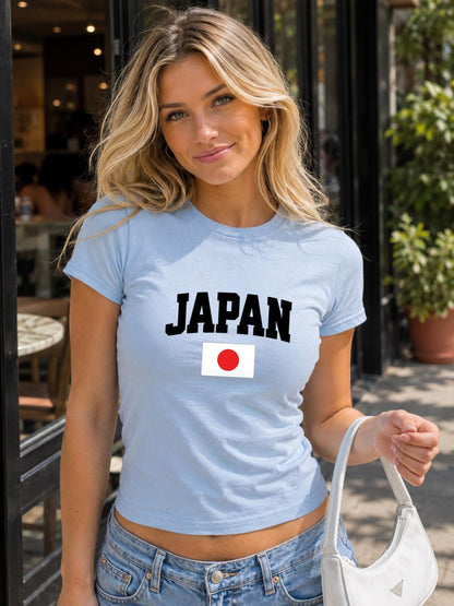 Blue baby tee with bold white JAPAN text and Japan flag graphic