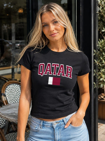 Maroon baby tee with bold QATAR lettering and Qatar flag graphic