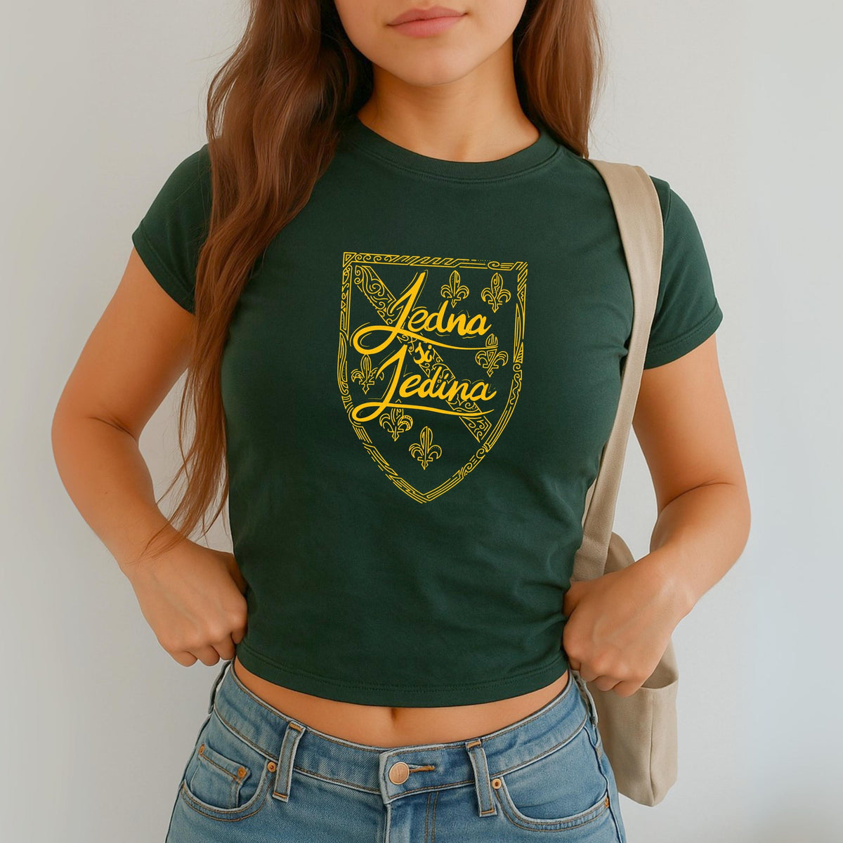 Blue baby tee with yellow Jedina si Jedina shield design and fleur-de-lis details