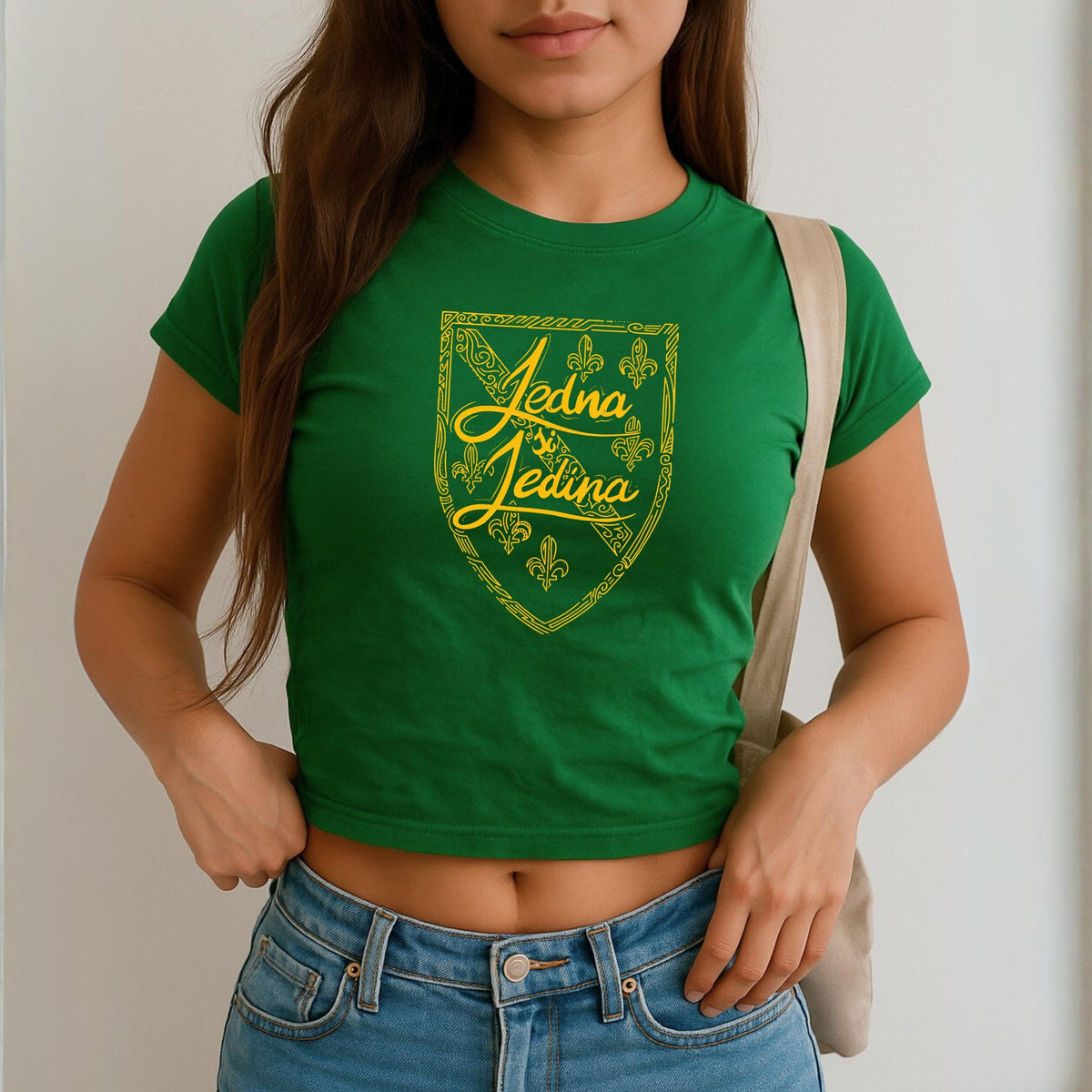 Blue baby tee with yellow Jedina si Jedina shield design and fleur-de-lis details