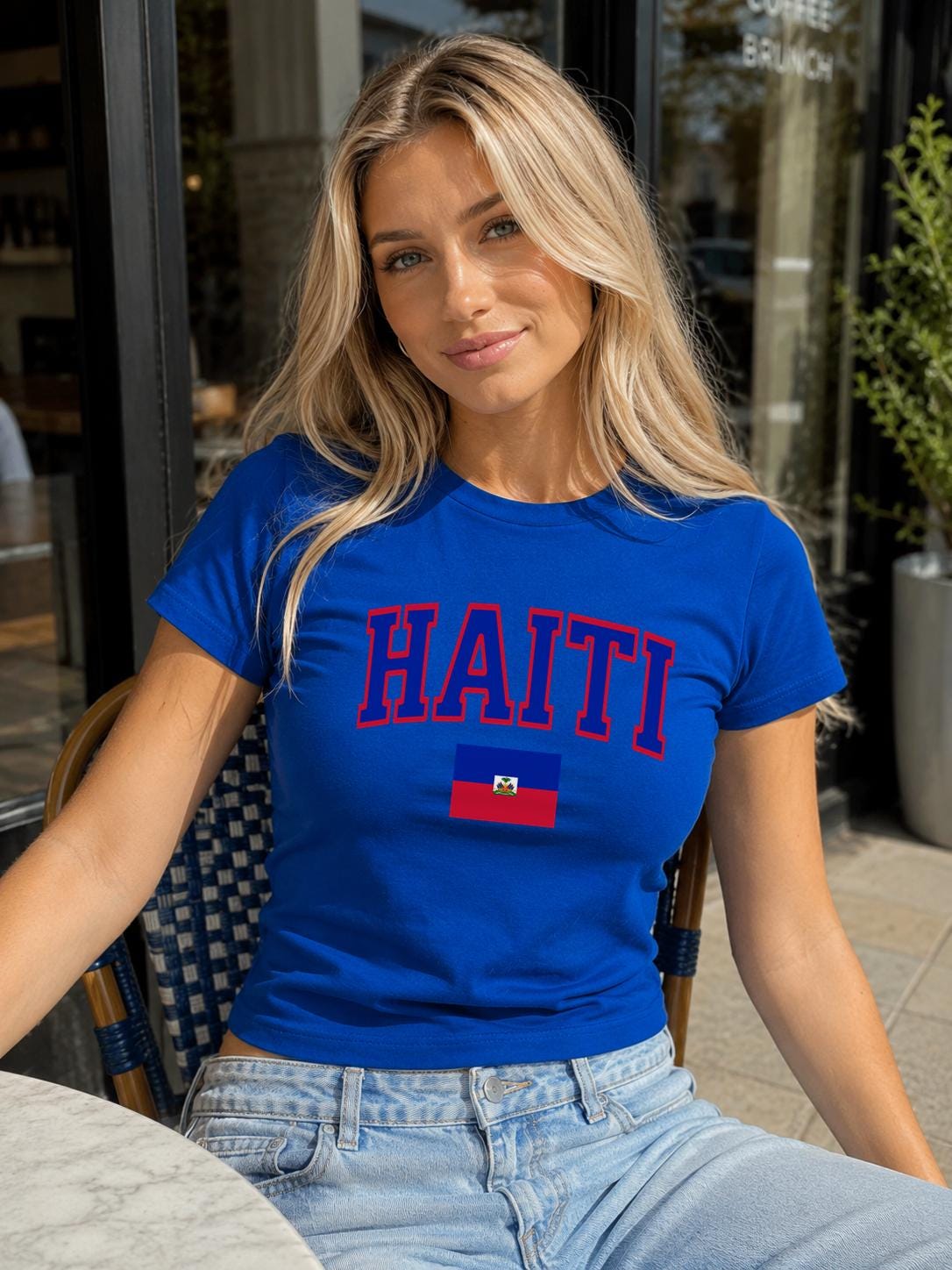 Navy baby tee with bold HAITI varsity lettering and Haitian flag graphic