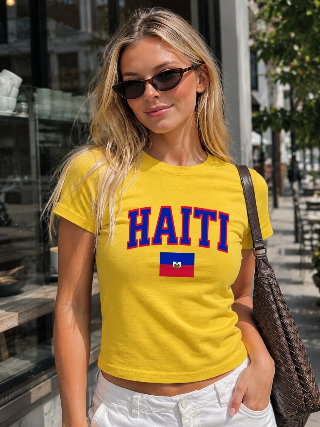 Navy baby tee with bold HAITI varsity lettering and Haitian flag graphic