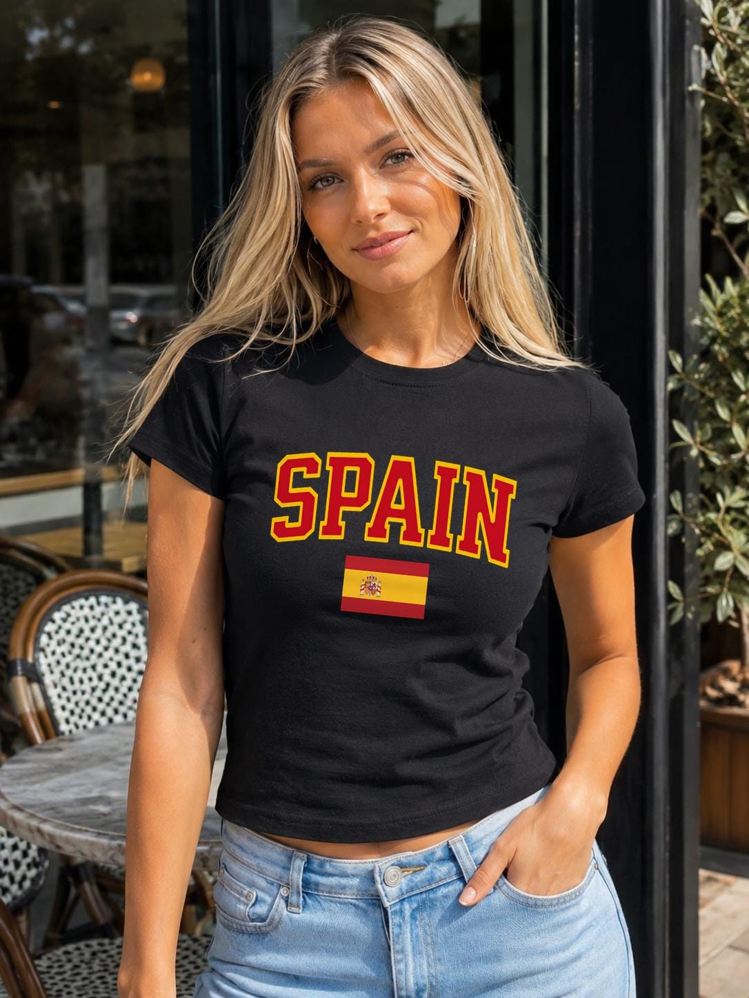 Spain baby tee with bold varsity lettering and Spanish flag graphic