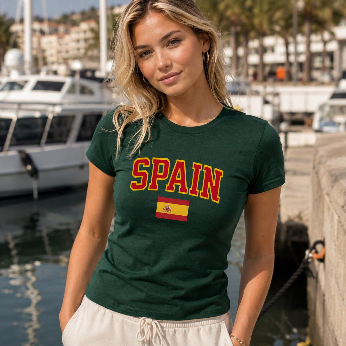 Spain baby tee with bold varsity lettering and Spanish flag graphic
