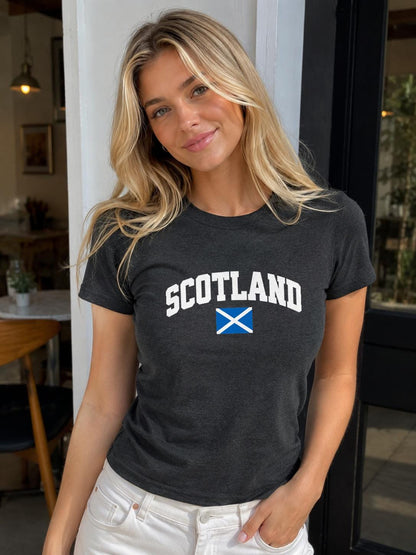 Blue baby tee with bold white Scotland lettering and Scottish saltire flag design