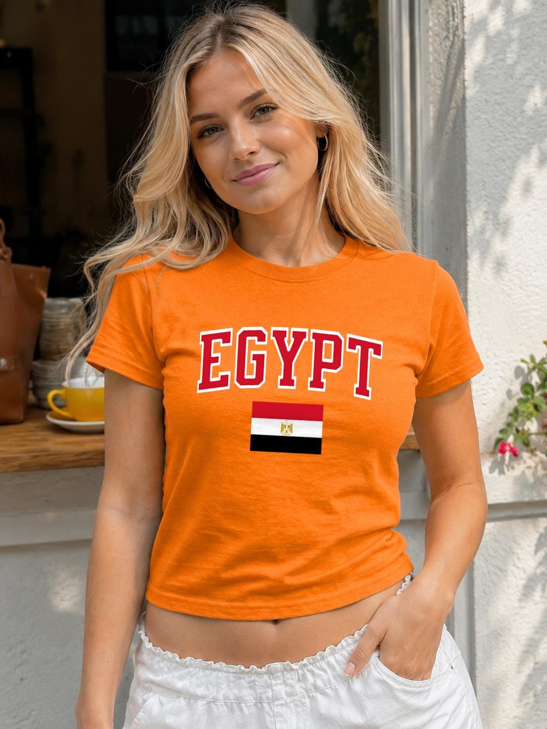 Black baby tee with red EGYPT varsity lettering and Egyptian flag graphic.