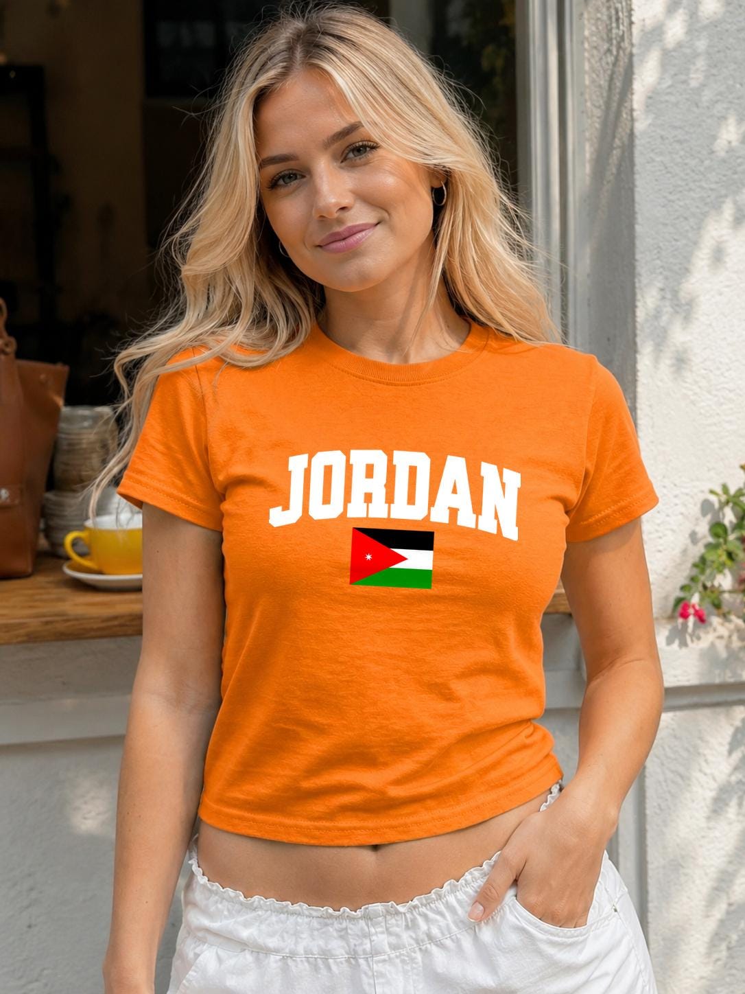 Green baby tee with bold JORDAN lettering and the Jordanian flag on the chest