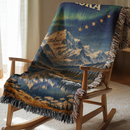 Alaska woven blanket with northern lights, mountain lake scene, gold stars, and fringe edges