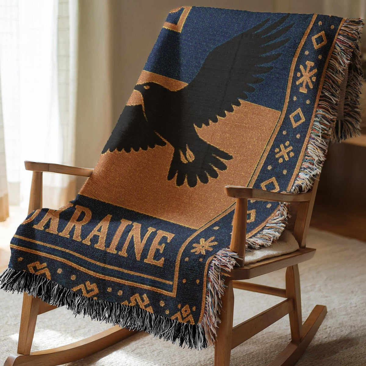 Woven Ukraine blanket with Tryzub trident, flying bird silhouette, folk border, and fringe edges