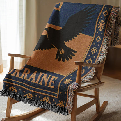 Woven Ukraine blanket with Tryzub trident, flying bird silhouette, folk border, and fringe edges