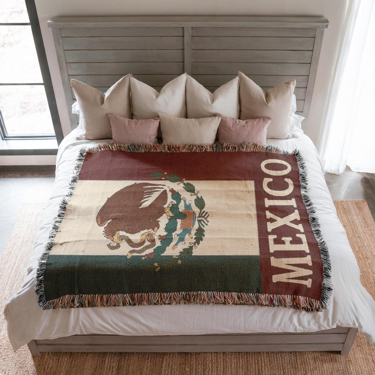 Woven blanket featuring the Mexico flag with eagle coat of arms and MEXICO text