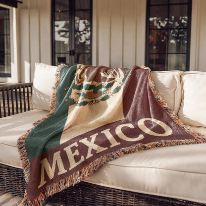 Woven blanket featuring the Mexico flag with eagle coat of arms and MEXICO text