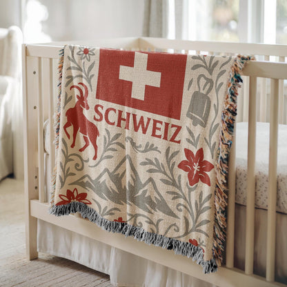 Woven blanket with Schweiz Swiss flag, alpine mountains, flowers, chalet, cowbell and ibex design