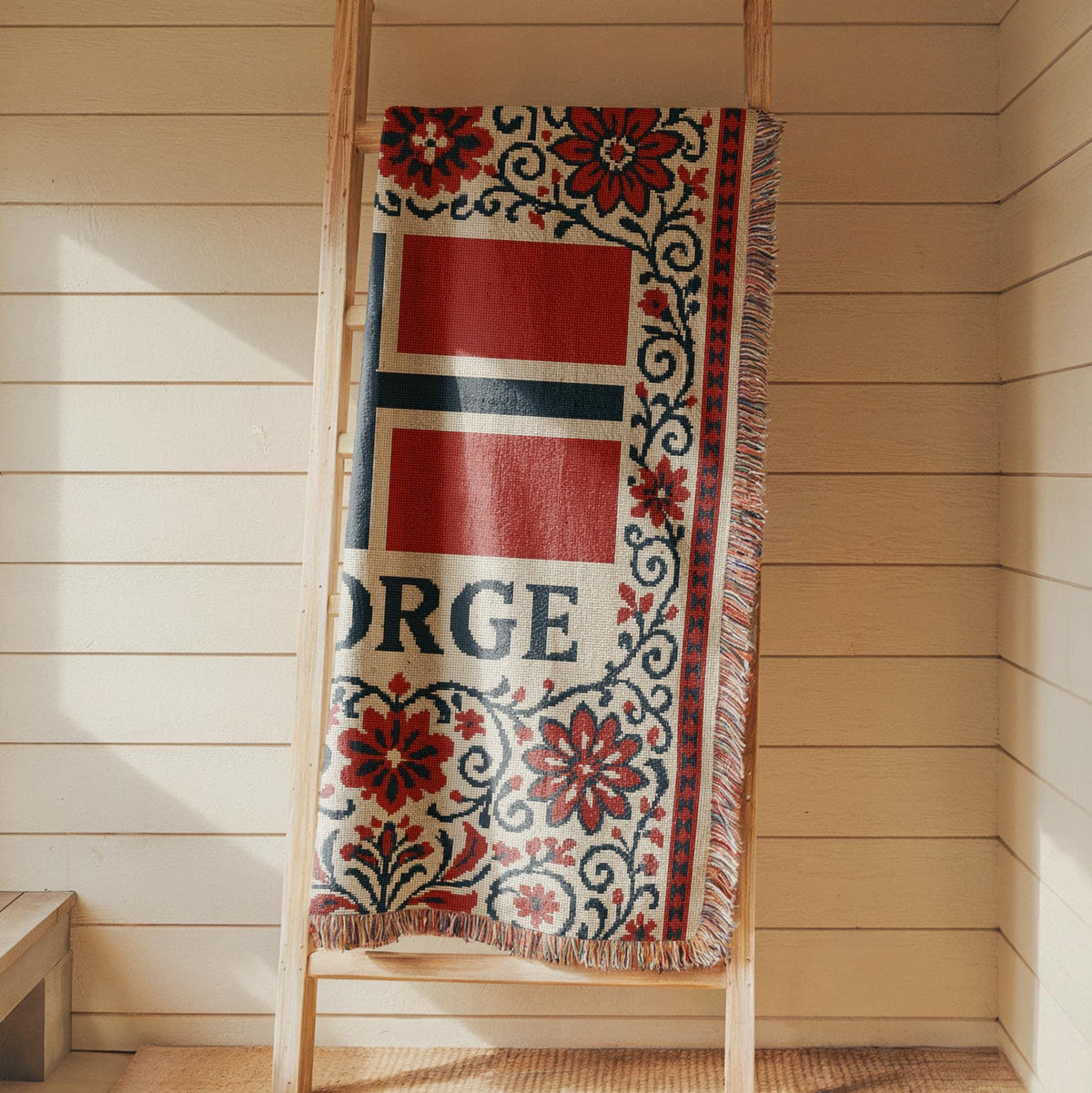 Woven blanket with Norway flag, NORGE text, red floral Nordic border, and fringe edges
