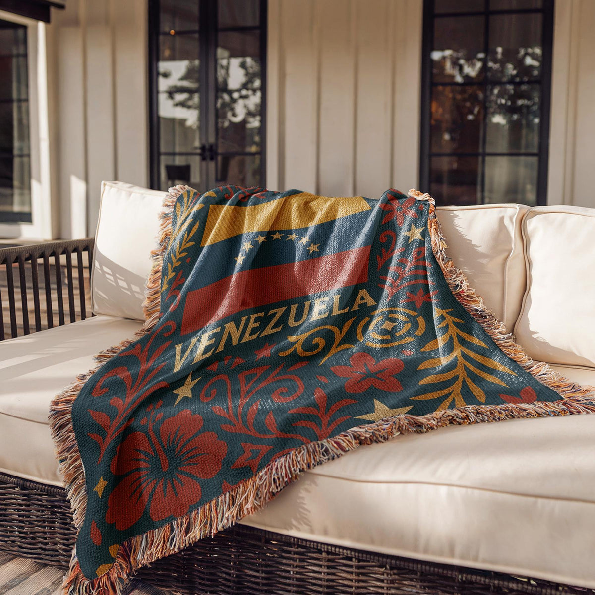 Woven blanket with Venezuela flag, Venezuela text, stars, palm tree and red floral folk art