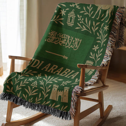 Green Saudi Arabia woven blanket with Arabic script, camel, palm trees, sword, lanterns, and fringe edges